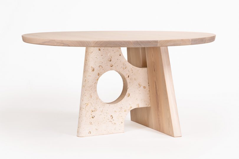 round light wood table with perpendicular legs on white background