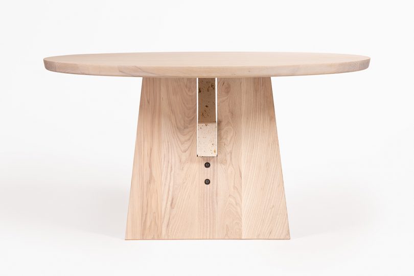 round light wood table with perpendicular legs on white background