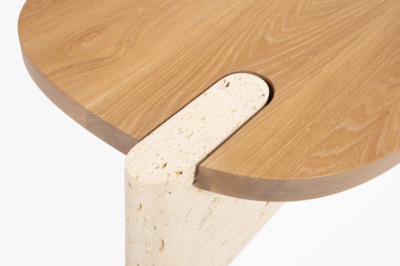 detail of oval two toned wood coffee table on white background