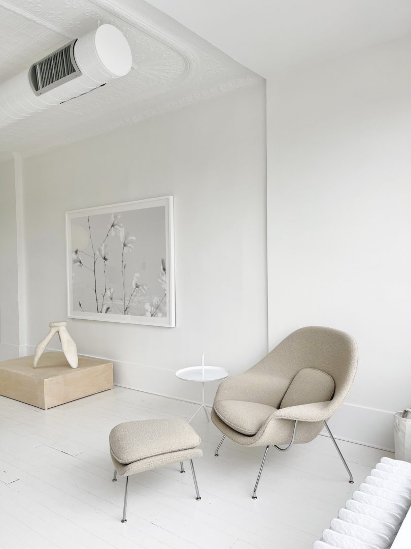 A Womb Chair sits in the corner by Eero Saarinen