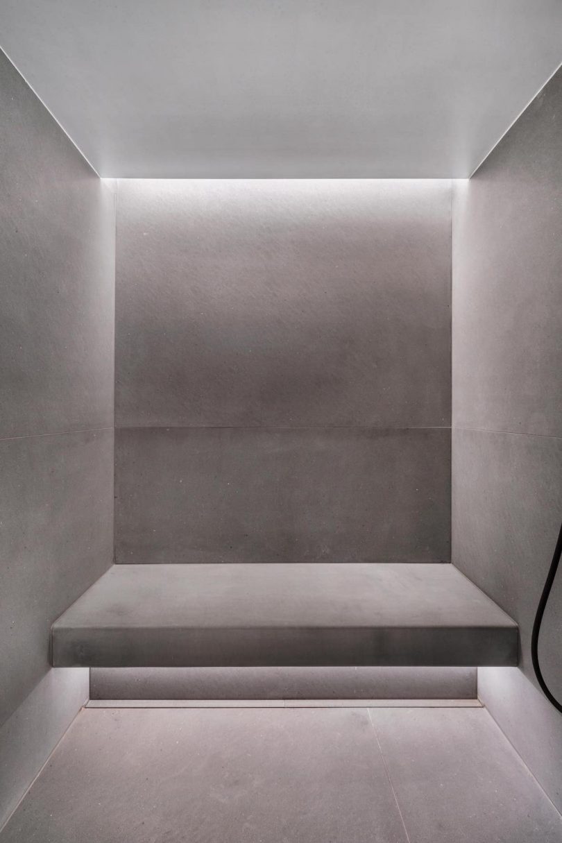 interior shot of gray bathroom with minimalist walls