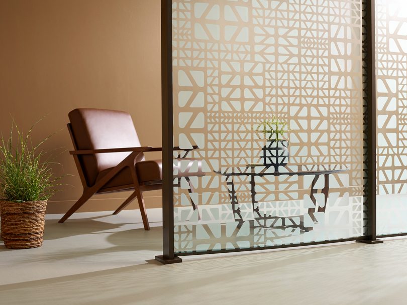 etched glass space divider with an armchair