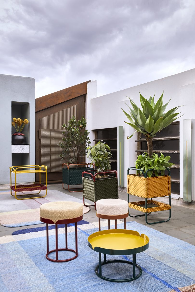 three colorful side tables of varying heights in use outdoors