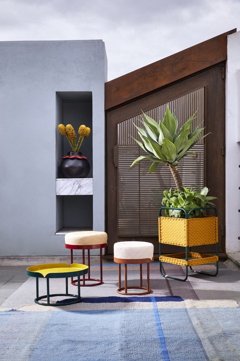 three colorful side tables of varying heights in use outdoors