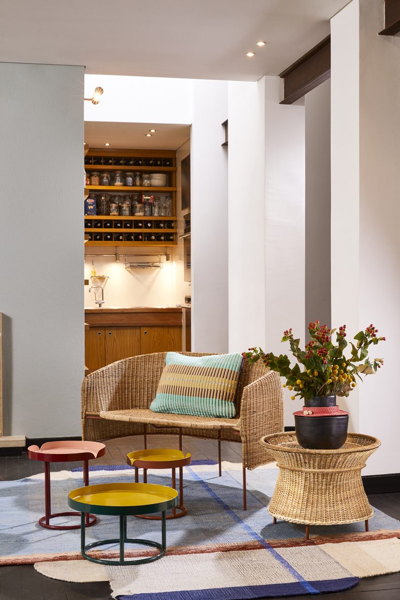 styled indoor living space with wicker chair and side tables