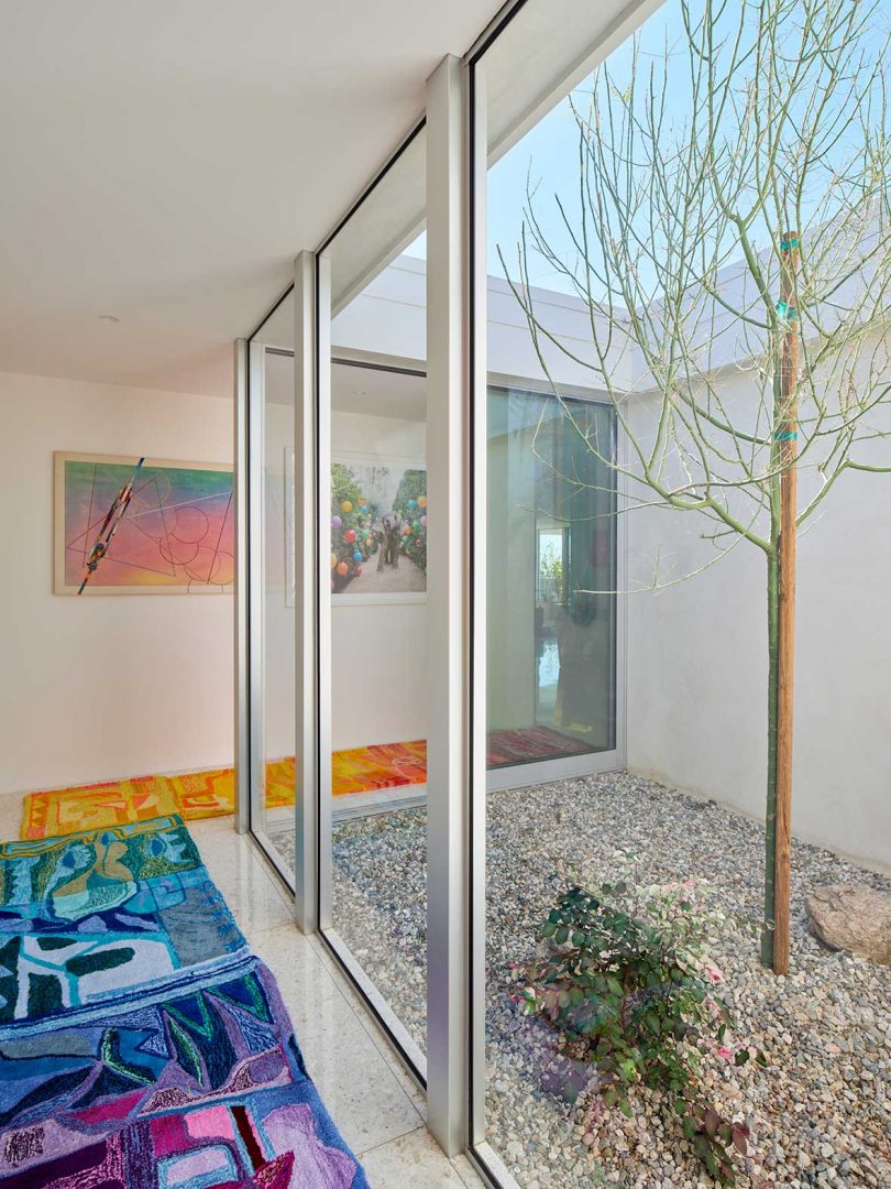 hallway view with colorful rug and view of interior courtyard