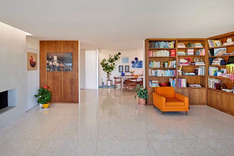 interior of mid-century modern home with bookshelf corner and orange accents