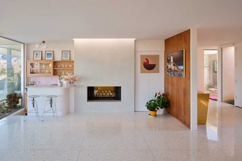 interior of mid-century modern home with wood wall and fireplace