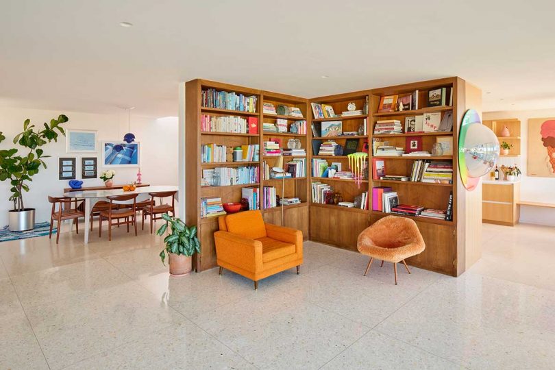 interior of mid-century modern home with bookshelf corner and orange accents