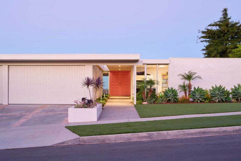 cropped view of front of mid-century modern house with orange doors