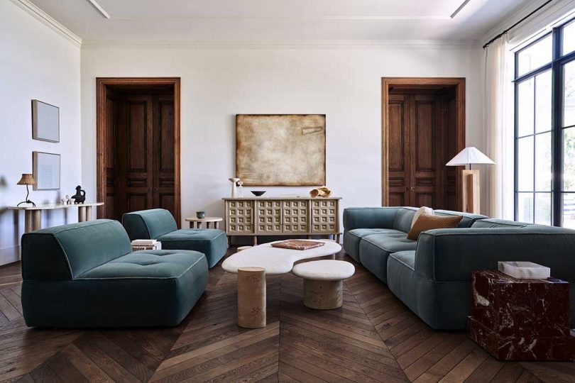 modern living room with two green velvet sofas facing each other