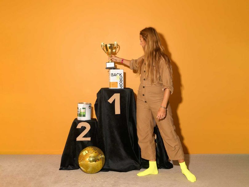 gold orange yellow wall with winner trophy stand