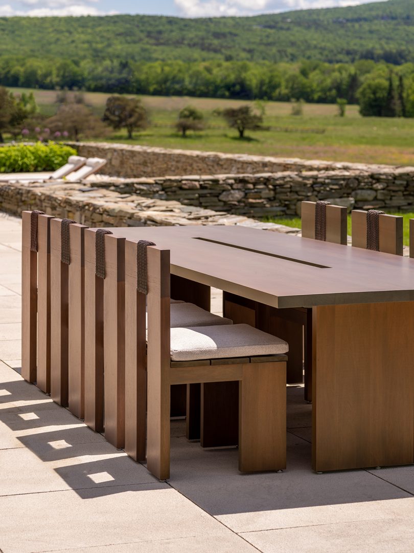 outdoor dining set sitting outside with chairs pushed in to long rectangular table
