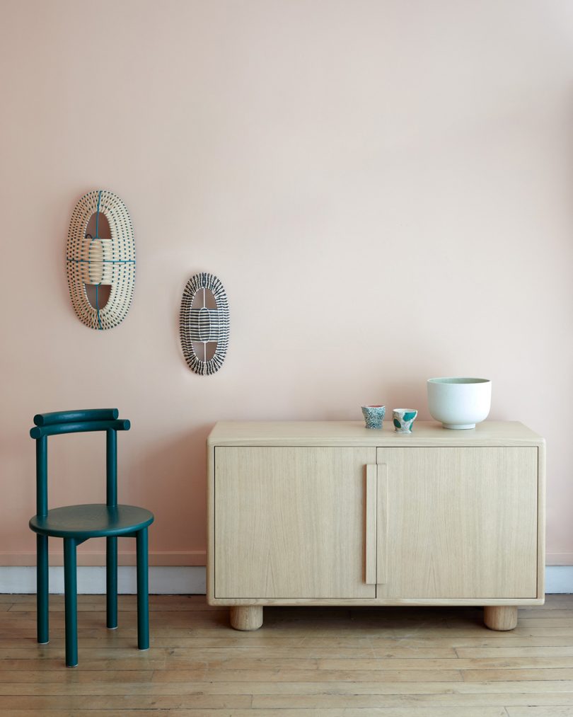 light wood sideboard in a styled space with dining chair and 3D wall art