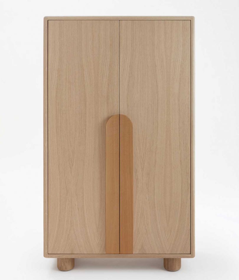 light wood armoire on white background