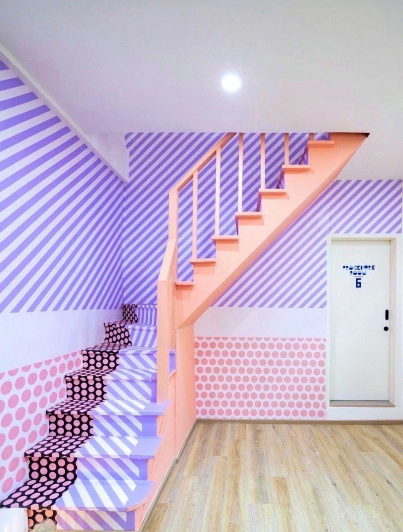 interior view of pink staircase with patterned risers and walls