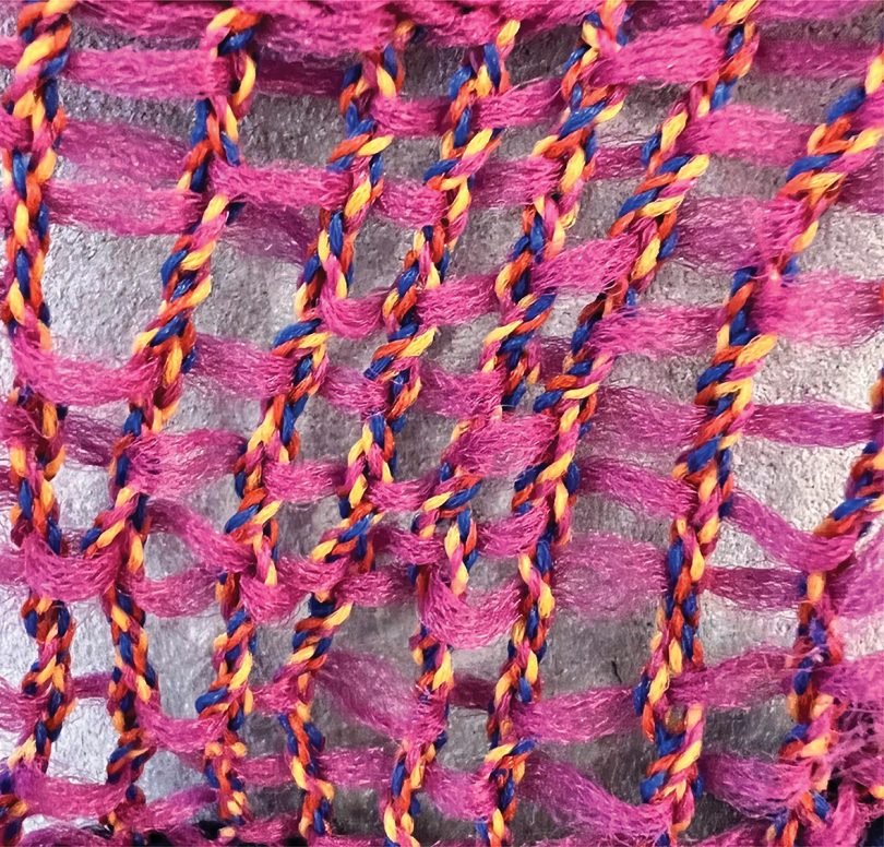 detail of hand-woven pink and multi-color drapery