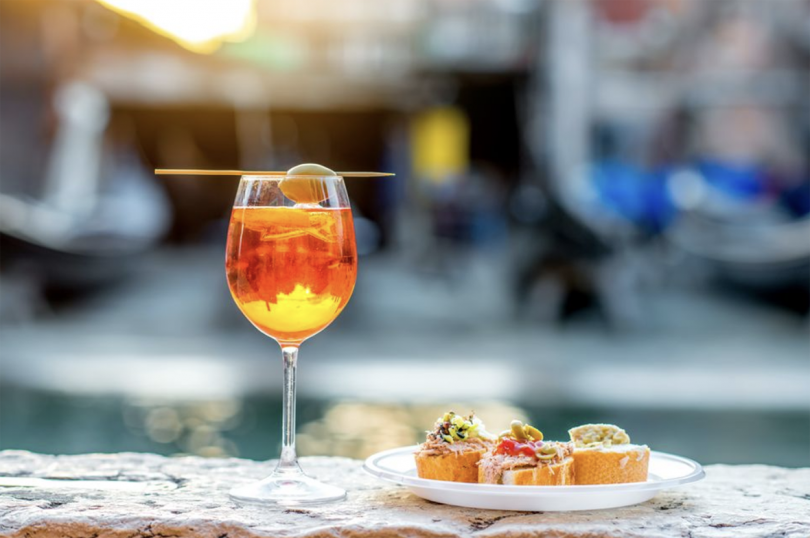Aperol spritz with appetizers outdoors
