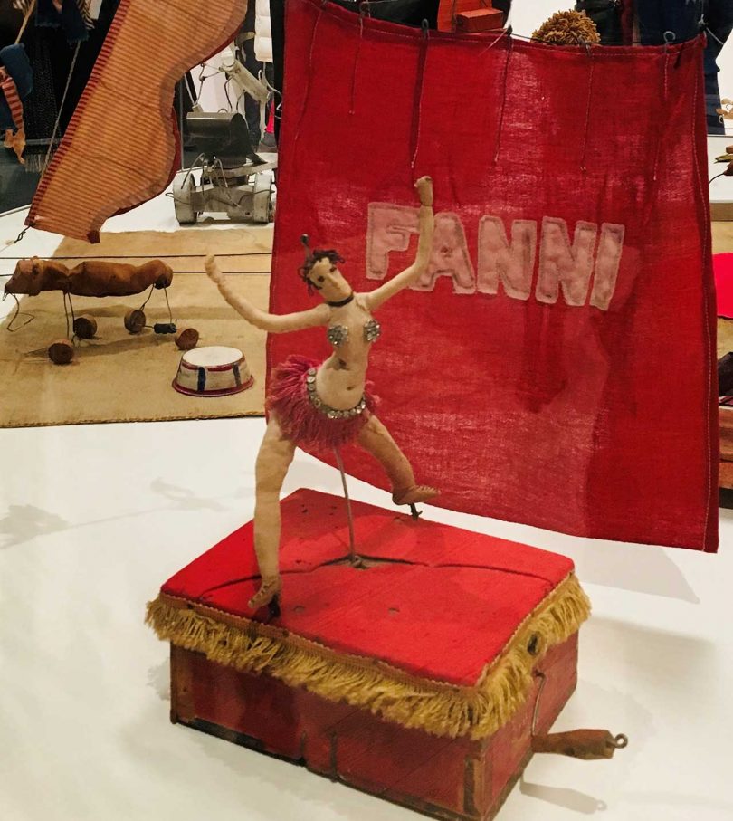 vintage circus memorabilia featuring a dancing woman standing on top of a red box
