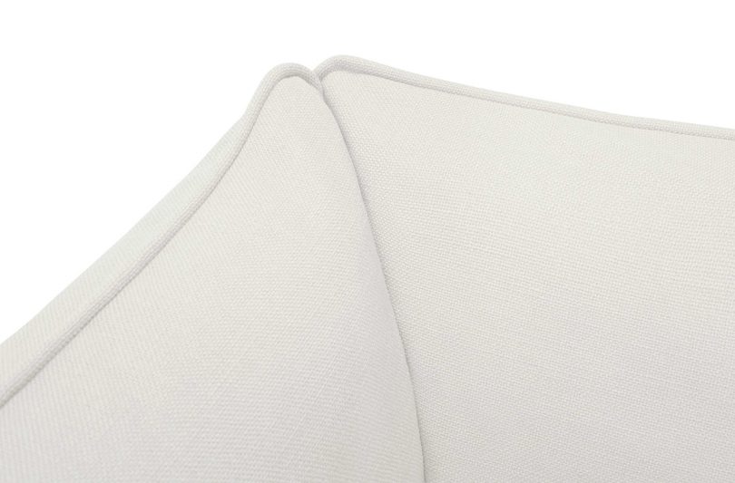 corner of white upholstered furniture on white background