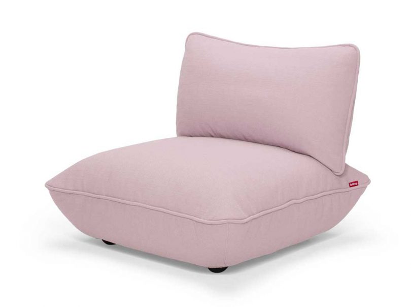 light pink upholstered chair on white background