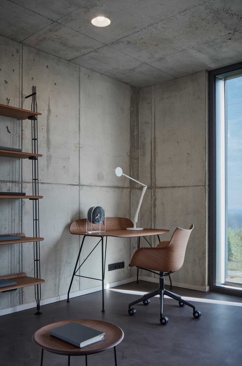 interior office space with concrete walls and wood desk