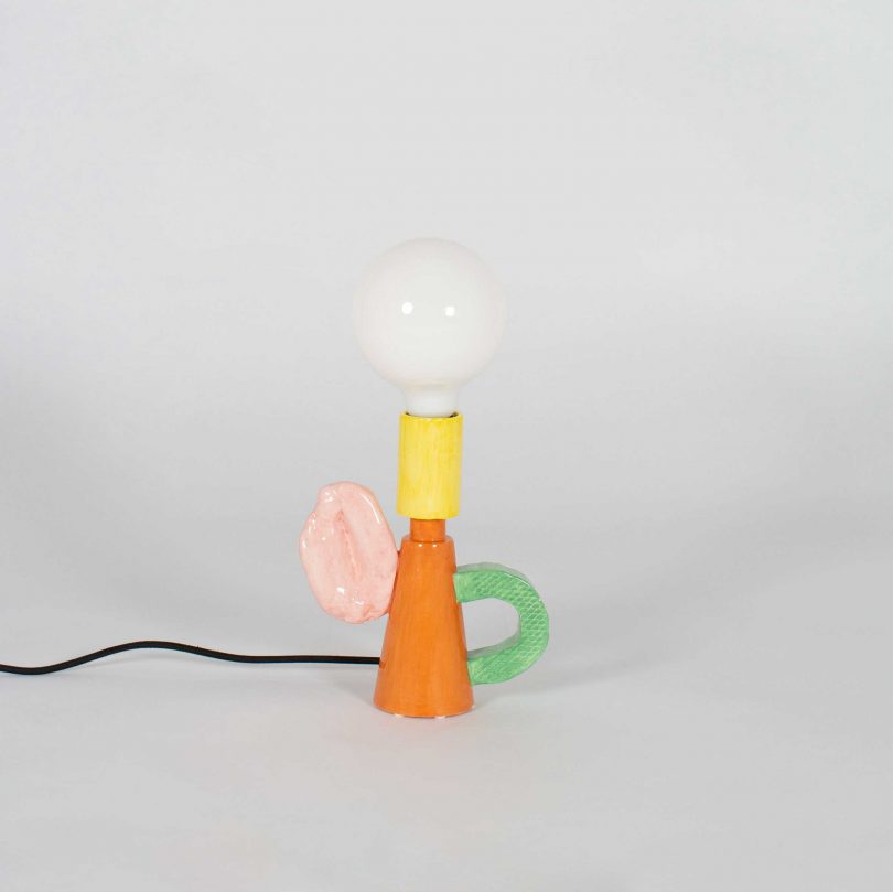 colorful shade-free table lamp on a light grey background