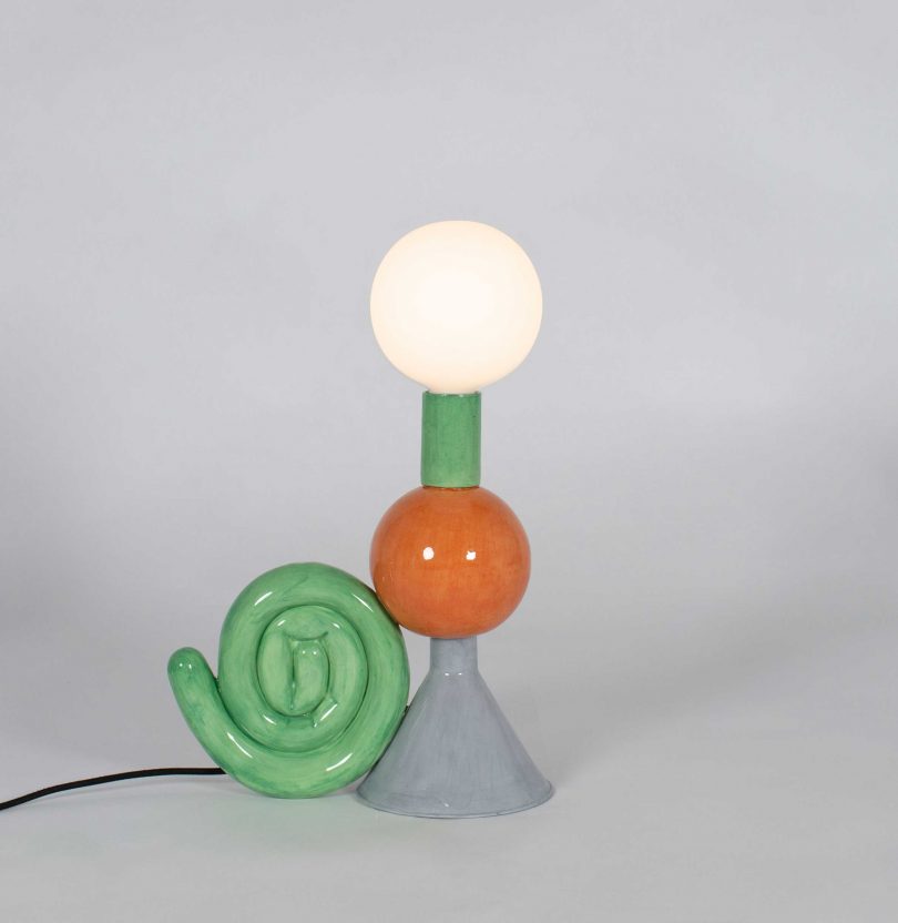 colorful shade-free table lamp on a light grey background