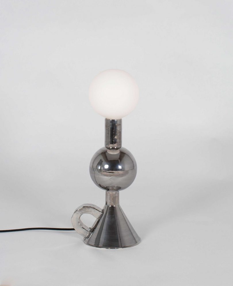 mirrored shade-free table lamp on a light grey background