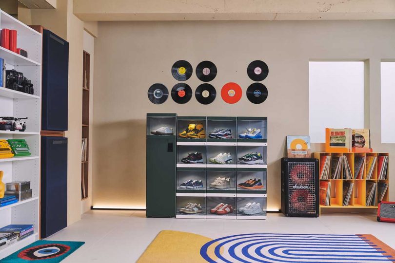 A 3 x 4 grid of dark green LG Styler ShoeCases with sneakers inside with Styler ShoeCare on right set in youth sneakerhead staged bedroom with records on the wall.