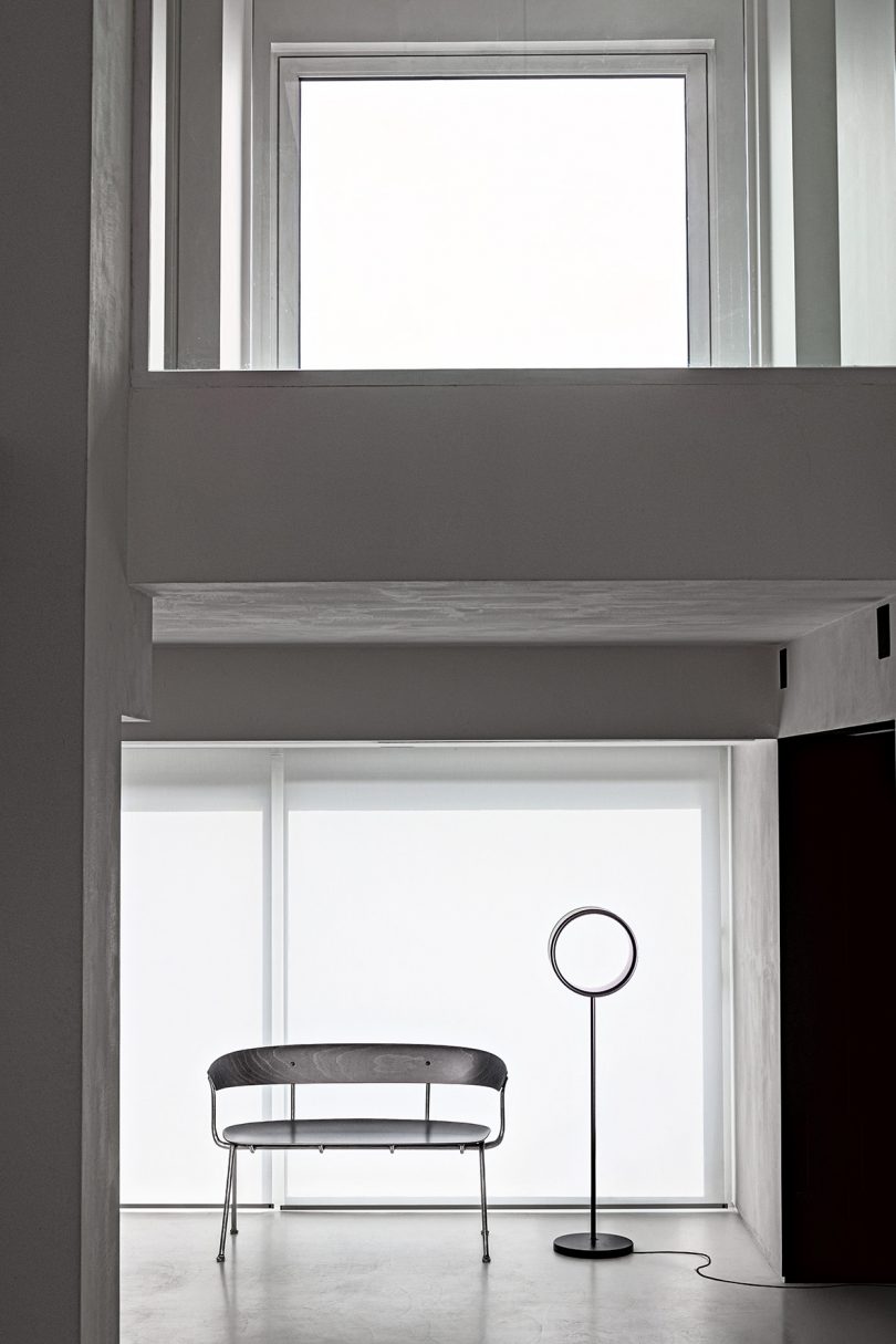 minimal floor lamp with hollow ring in a styled interior space