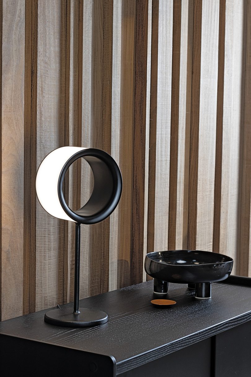 minimal table lamp with hollow ring in a styled interior space