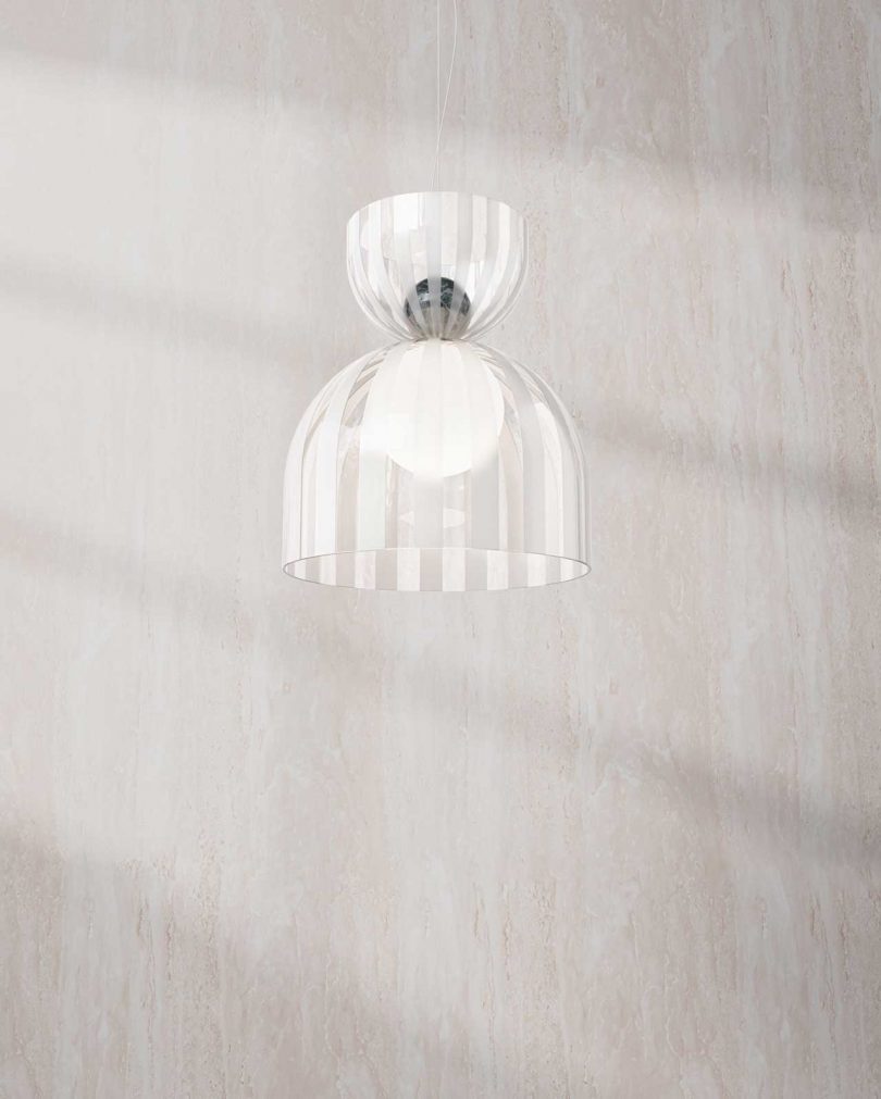 glass ceiling lamp hanging in front of a blank wall