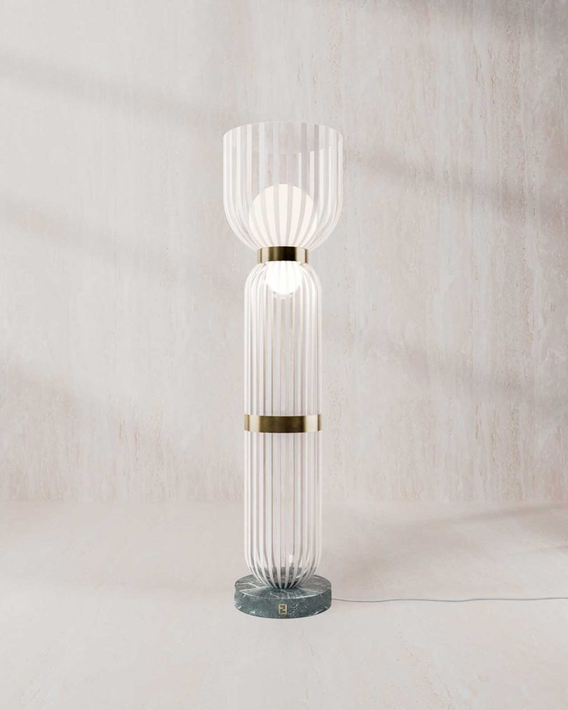 glass floor lamp in front of a blank wall