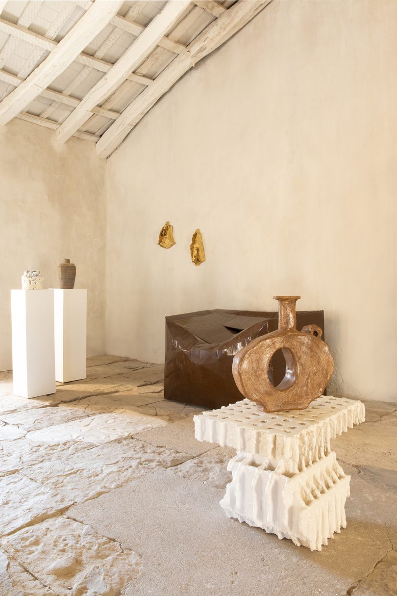 exhibition of white plaster furniture in a gallery space