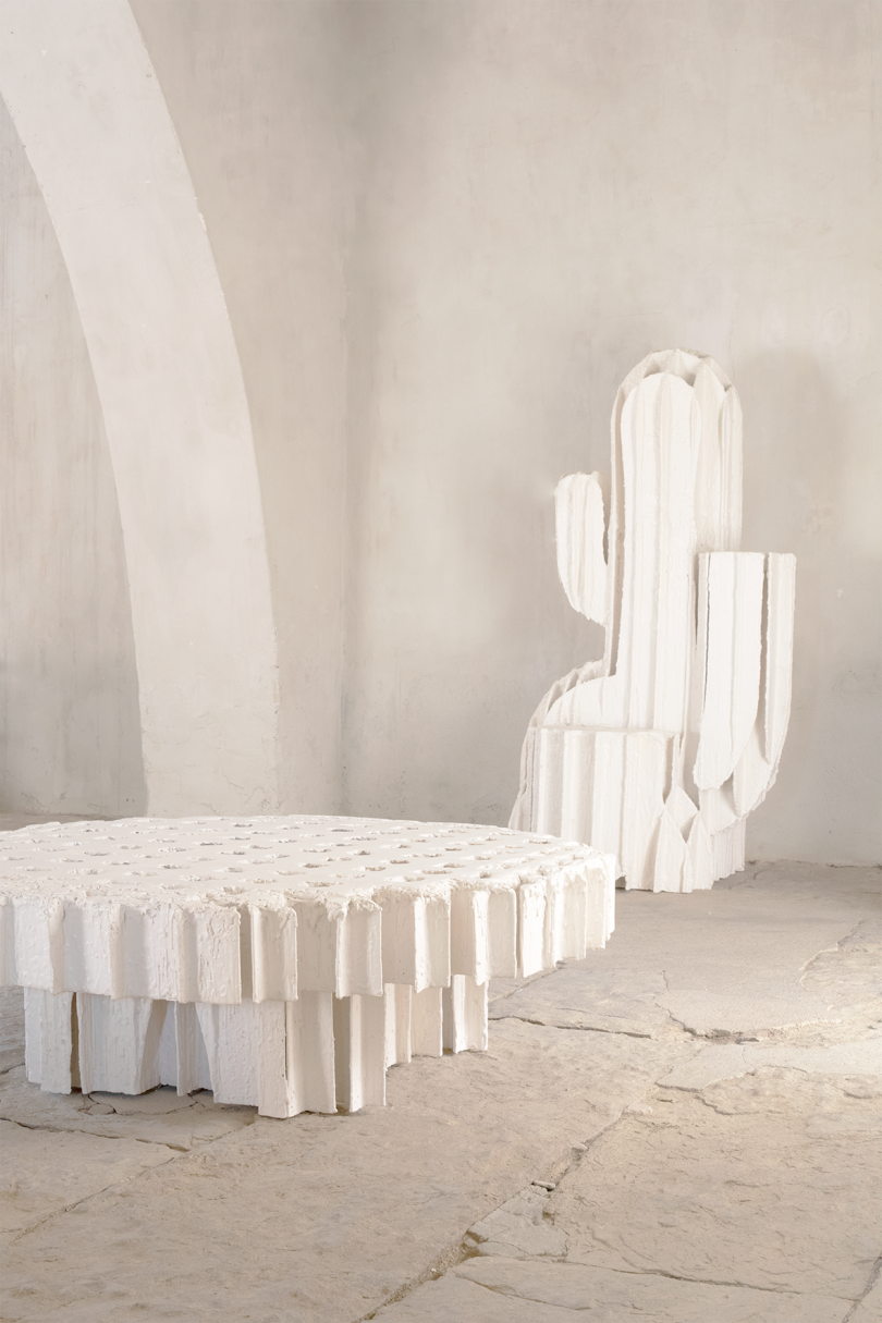 white plaster cactus and coffee table in a gallery space