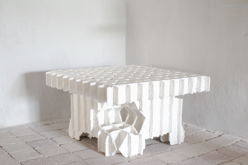 white plaster table in a gallery space