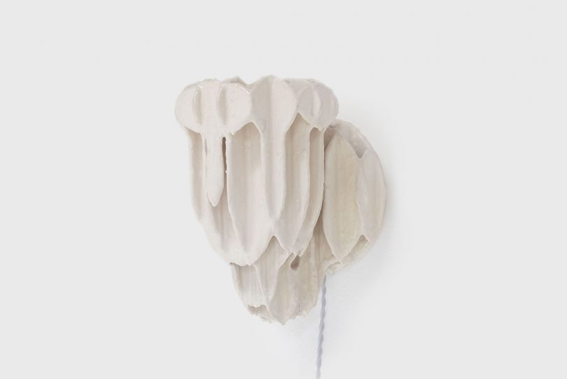 white plaster wall sconce on a white background