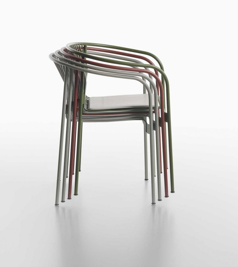 stack of wire armchairs on white background