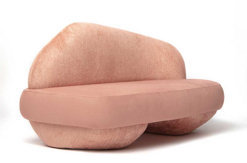 rounded pink sofa on white background