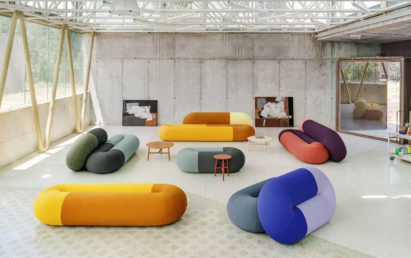 gallery space filled with colorful abstract sofas