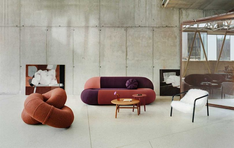 gallery space filled with warm-toned abstract sofas