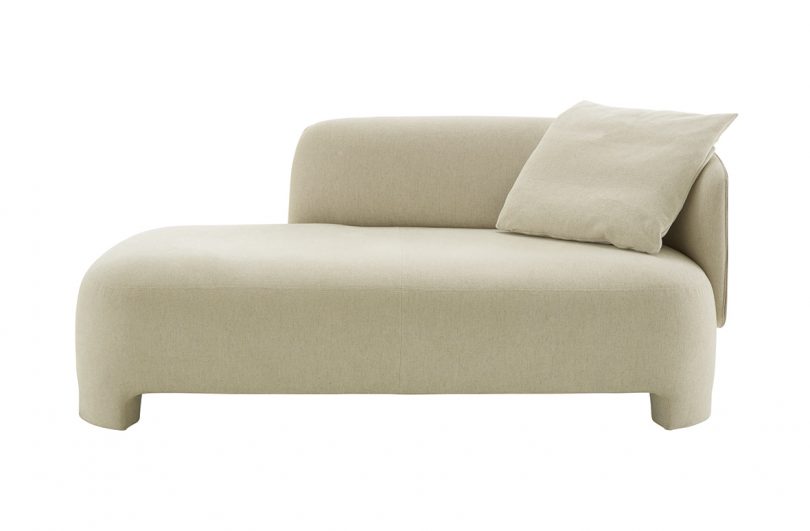 cream upholstered lounge chair on white background