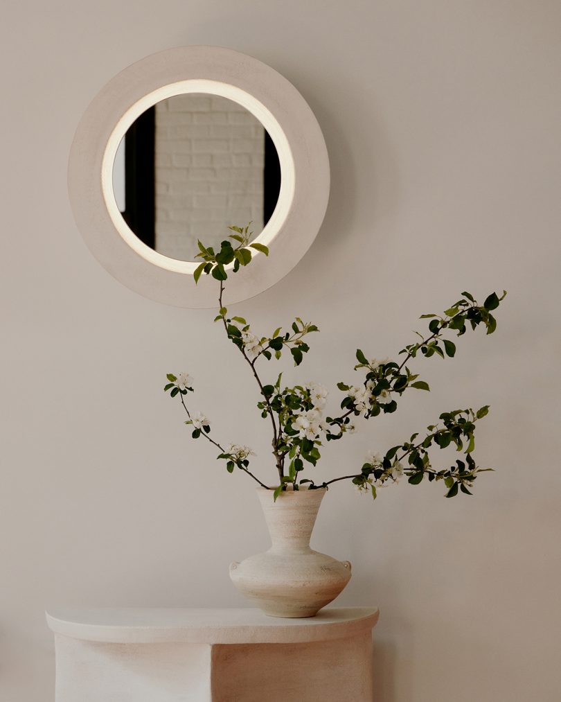 round mirror with illuminating light circle hanging on the wall