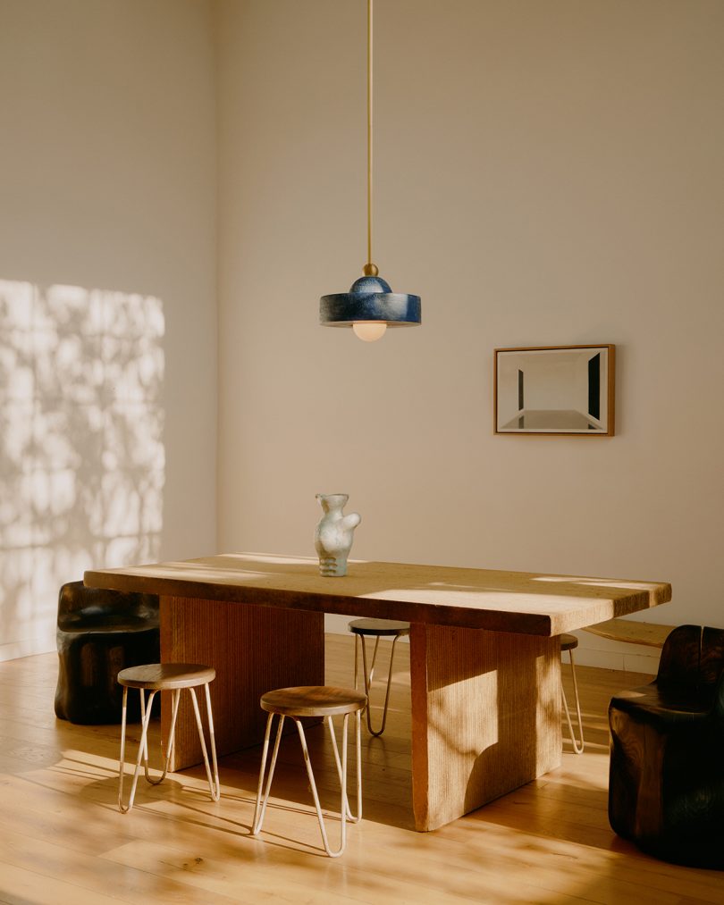 dark pendant light hanging over a table