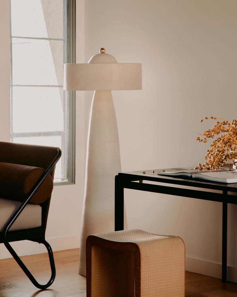 tall white floor lamp in styled living space