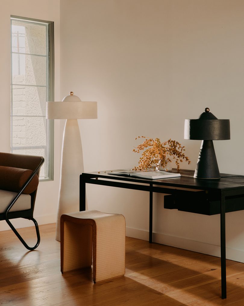 tall white floor lamp and matching black table lamp in styled living space