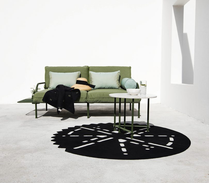 outdoor sofa, nesting tables, and round black mat