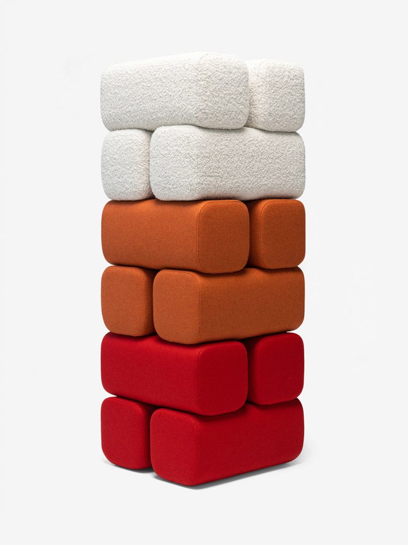 stacked red, orange, and white pouf on a white background