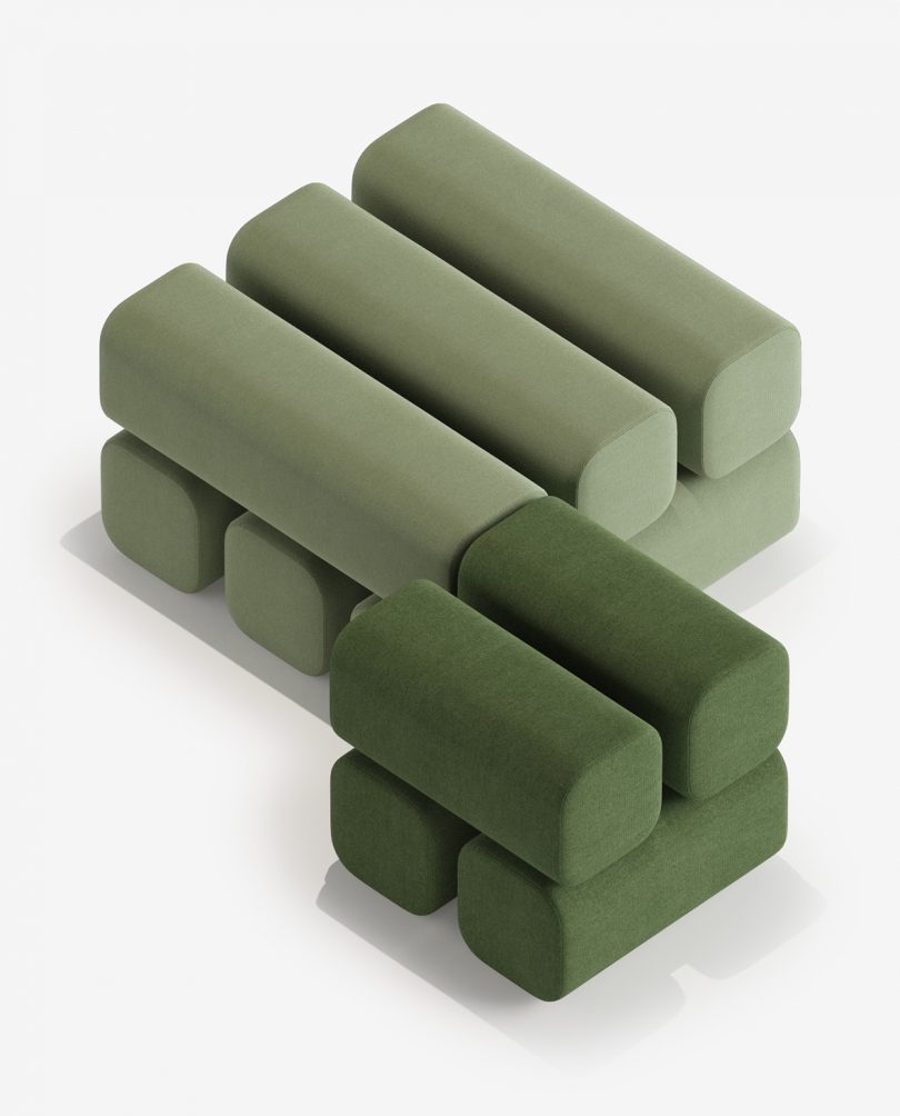 two green square poufs of different sizes next to each other on a white background